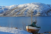Boat anchored in river in harsh winter